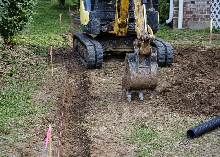 Mini excavator trench layout and bucket check Mini excavator bucket and trench layout check for a small property drainage job