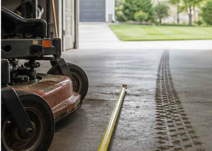 Garage storage scene with mower deck width and measuring tape