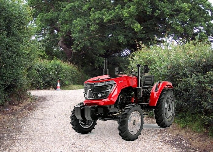 Compact tractor three-point hitch compatibility check Owner checking a compact tractor three-point hitch before connecting an implement