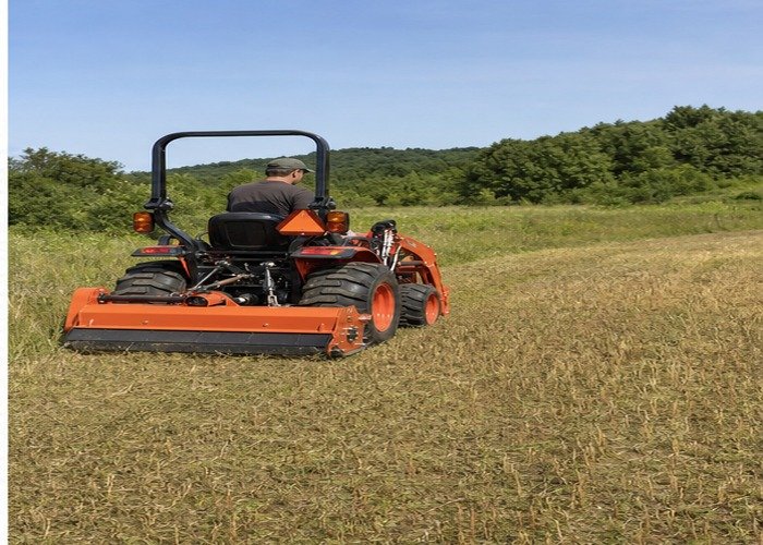 Compact tractor completing an even flail-mowed finish pass Compact tractor completing an even flail-mowed finish pass