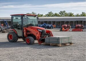 Compact tractor carrying a centered pallet low on correctly spaced forks