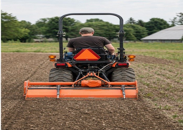 Compact tractor completing a straight first tillage pass with aligned PTO driveline