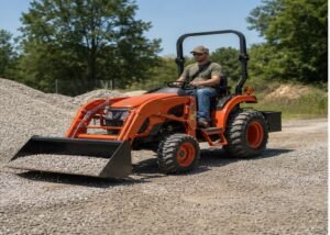 Compact tractor moving gravel with the loader bucket low and rear ballast installed