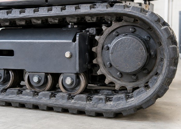 Close inspection of mini excavator sprocket and lower rollers