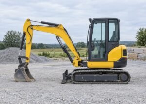 Illustrative parked mini excavator with grounded bucket and unoccupied cab