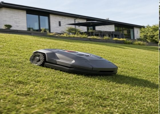 All-wheel-drive robotic lawn mower traversing a moderate dry lawn slope