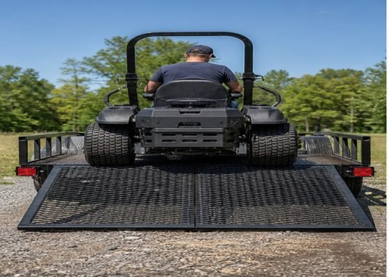 Zero-turn mower backing up a full-width trailer ramp